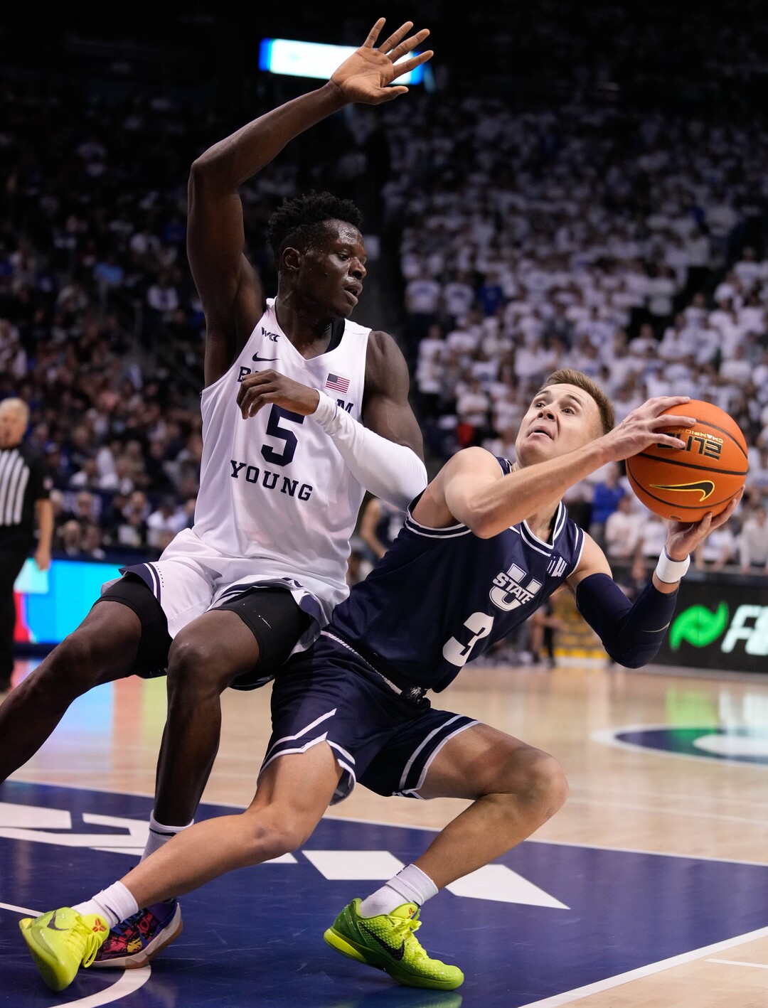 (Francisco Kjolseth | The Salt Lake Tribune) Utah State Aggies guard RJ Eytle-Rock (5) tries to block Brigham Young Cougars guard Te'Jon Lucas (3) in basketball action between the Brigham Young Cougars and the Utah State Aggies at the Marriott Center in Provo, Wednesday, Dec. 8, 2021.