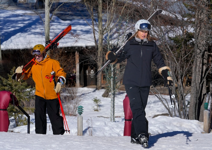 (Bethany Baker | The Salt Lake Tribune) Jackie Freiberg, right, and Kevin Freiberg carry their skiis to the lift at Sundance Resort near Provo on Thursday, Dec. 14, 2023.