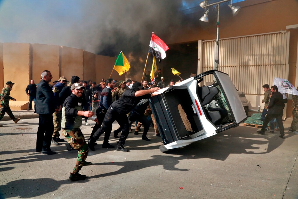 (Khalid Mohammed | AP file photo) Pro-Iranian militiamen and their supporters damage property inside the U.S. embassy compound in Baghdad, Iraq on Dec. 31, 2019.