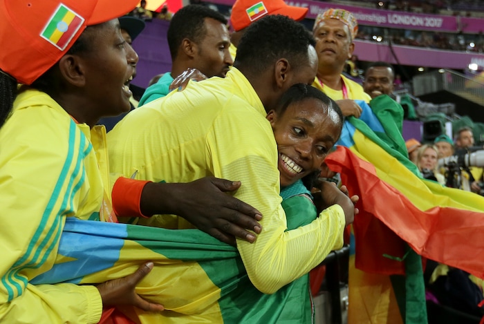 Ethiopia's Almaz Ayana, right, celebrates winning the Women's 10,000 meters final during the World Athletics Championships in London Saturday, Aug. 5, 2017. (AP Photo/Tim Ireland)