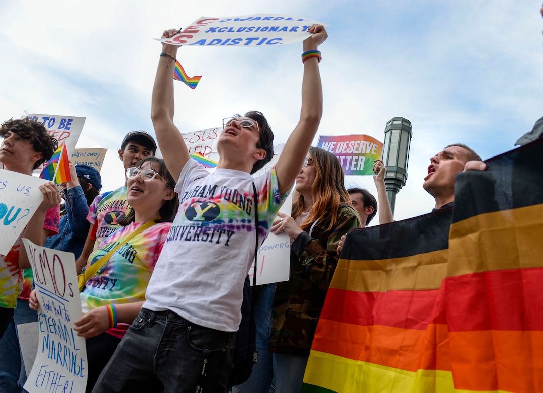 (Leah Hogsten  |  The Salt Lake Tribune) BYU student Trevor Schoeny repeats ÒGod loves queersÓ with Ryan Jenks, right, who started the chant with hundreds of other students and supporters Friday. Brigham Young University LGBTQ students took their concerns about the schoolÕs policy reversal regarding romantic behavior by same-sex couples to The Church of Jesus Christ of Latter-day Saints office building, Mar. 6, 2020. Despite removing the section on Òhomosexual behaviorÓ from BYU Honor Code last month, The LDS Church has clarified for the first time that same-sex romantic behavior is still Ònot compatibleÓ with the rules at BYU.