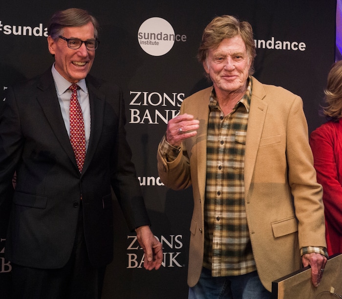 (Rick Egan  |  The Salt Lake Tribune)     Robert Redford receives an award from Scott Anderson, president and CEO of Zions Bank, at the 2018 Sundance Film Festival Utah Women’s Leadership Celebration in Park City on Thursday, Jan. 25, 2018.