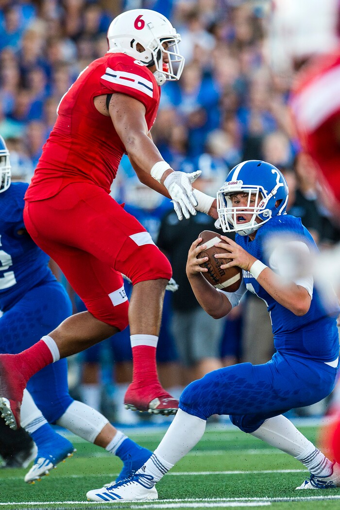 (Chris Detrick  |  The Salt Lake Tribune)  East's Johnson Hansen (6) puts pressure on Bingham's Ryan Wood (2) during the game at Bingham High School Friday, August 25, 2017. Bingham is winning the game 24-17 at halftime. 