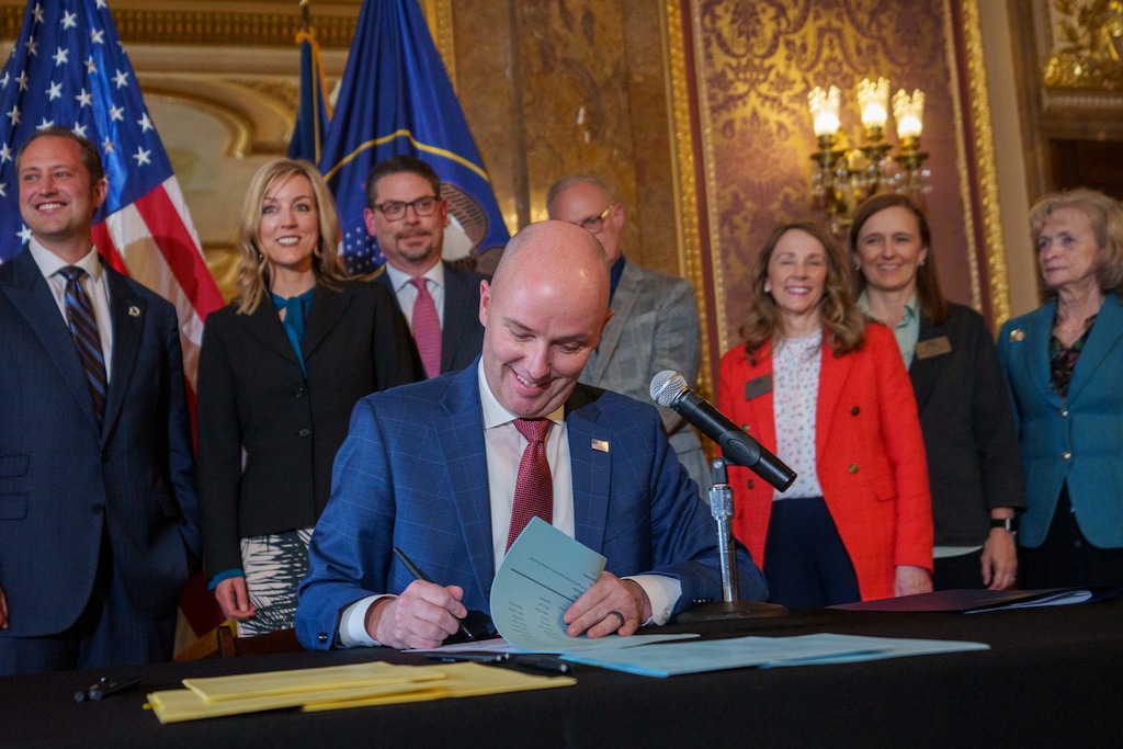 (Trent Nelson  |  The Salt Lake Tribune) Gov. Spencer Cox signs two social media regulation bills during a ceremony at the Capitol building in Salt Lake City on Thursday, March 23, 2023.