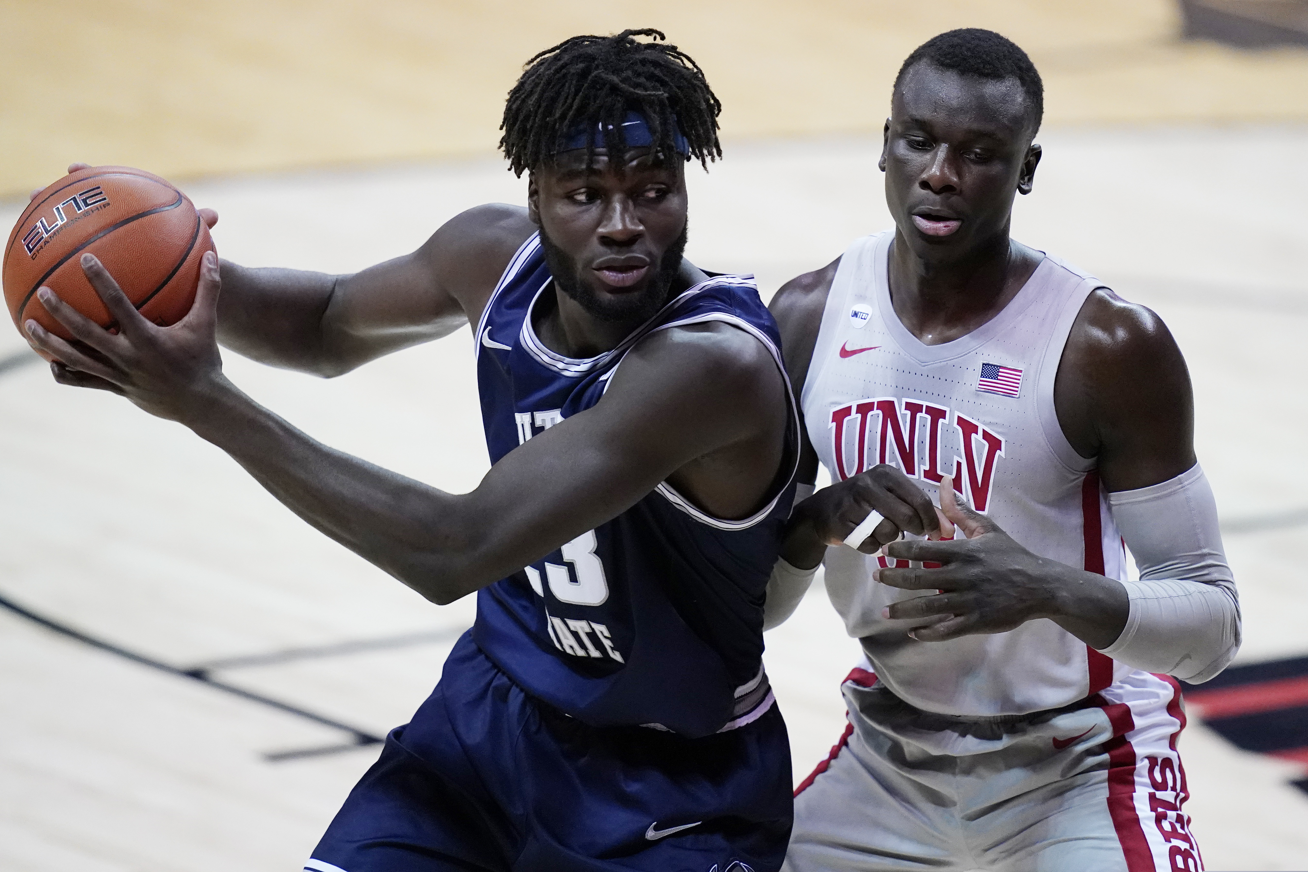 Utah State's Neemias Queta drives into UNLV's Cheikh Mbacke Diong during the first half of an NCAA college basketball game against Utah State, Wednesday, Jan. 27, 2021, in Las Vegas. (AP Photo/John Locher)