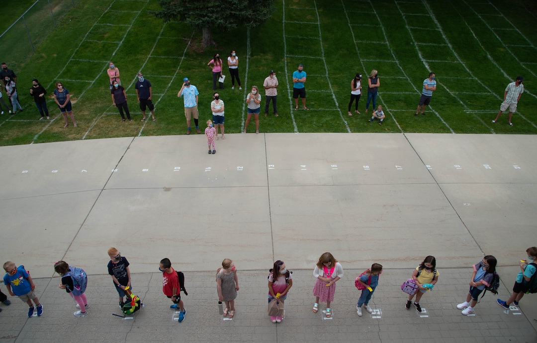 (Francisco Kjolseth  |  The Salt Lake Tribune) Parents keep their distance on the lawn marked for social distancing for the lunch hour as students at Canyon View Elementary in Cottonwood Heights line up for the first day classes for the Canyons School District on Monday, August 24, 2020.