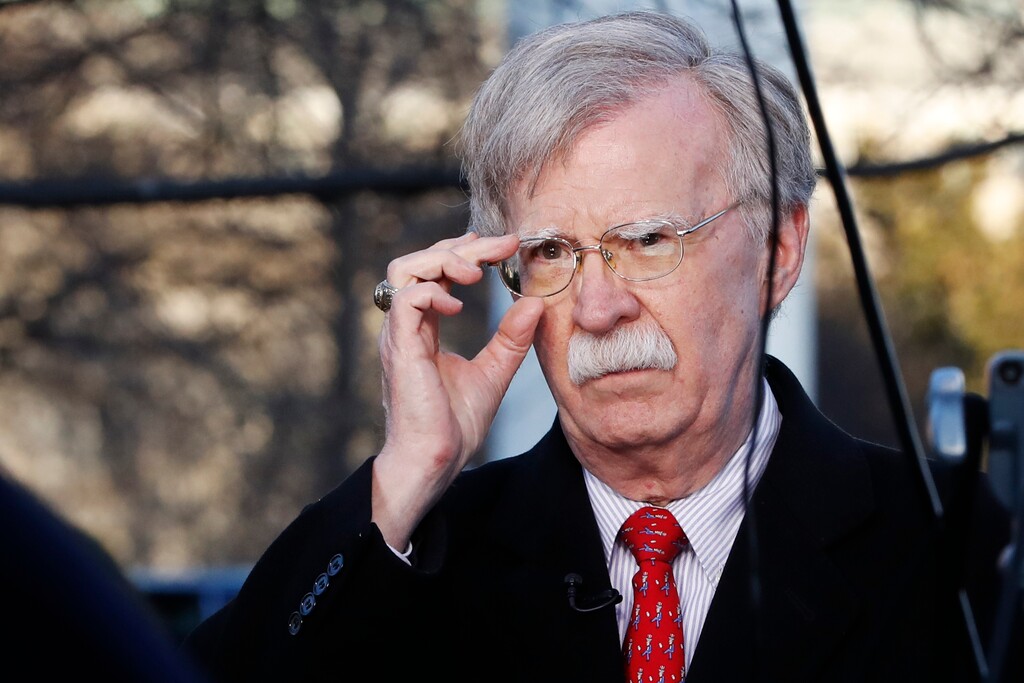 (Jacquelyn Martin | AP file photo) In this March 5 photo, then-national security adviser John Bolton adjusts his glasses before an interview at the White House in Washington.