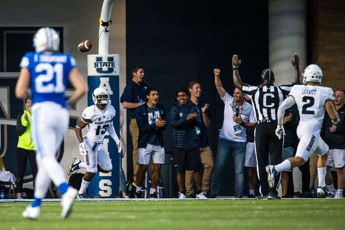 (Chris Detrick  |  The Salt Lake Tribune)  Utah State Aggies cornerback Jalen Davis (13) celebrates with Utah State Aggies safety Dallin Leavitt (2) after scoring a touchdown off of an interception during the game at Merlin Olsen Field at Maverik Stadium Friday, September 29, 2017.