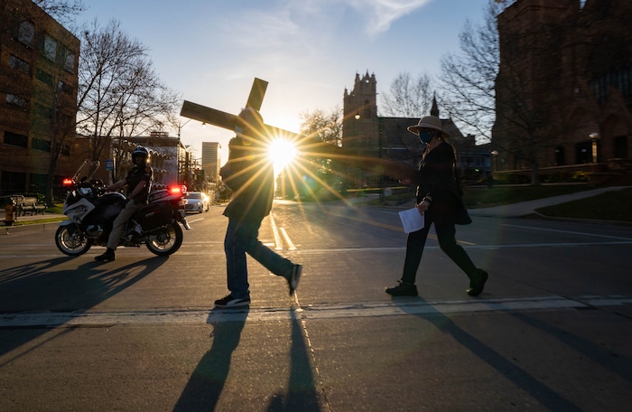 (Francisco Kjolseth | The Salt Lake Tribune) Mask wearing Utah Christians walk the streets of Salt Lake City beginning at Cathedral of the Madeleine on Good Friday, to symbolically mark Jesus' carrying the cross to his crucifixion, April 2, 2021.