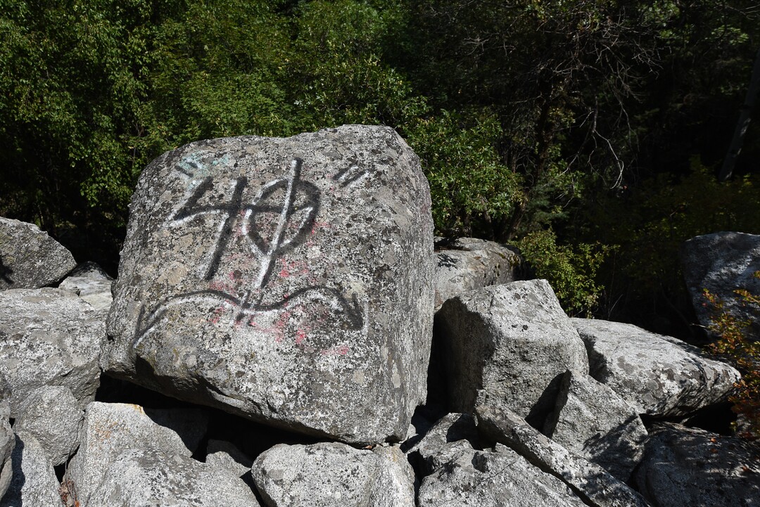 (Francisco Kjolseth  |  The Salt Lake Tribune)  Graffiti has proliferated in lower Little Cottonwood Canyon, where vandals, often wielding cans of fluorescent-colored spray paint, have covered granite faces, trees and structures. The vandalism is particularly apparent along the Temple Quarry Trail and the creek at the Moon Rock swimming hole and former pavilion site. Volunteers using donated equipment and solvents spend thousands of hours removing the paint from the rocks only to see graffiti return to the same faces or on rock nearby.