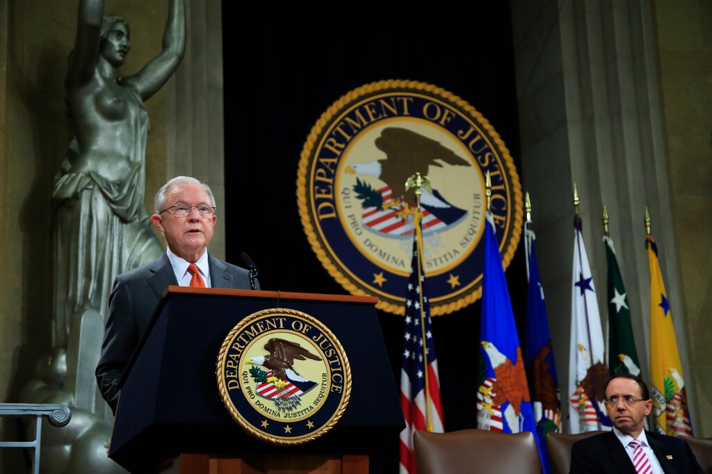 Attorney General Jeff Sessions speaks during a Religious Liberty Summit at the Department of Justice, Monday, July 30, 2018. Seated on the right is Deputy Attorney General Rod Rosenstein. (AP Photo/Manuel Balce Ceneta)