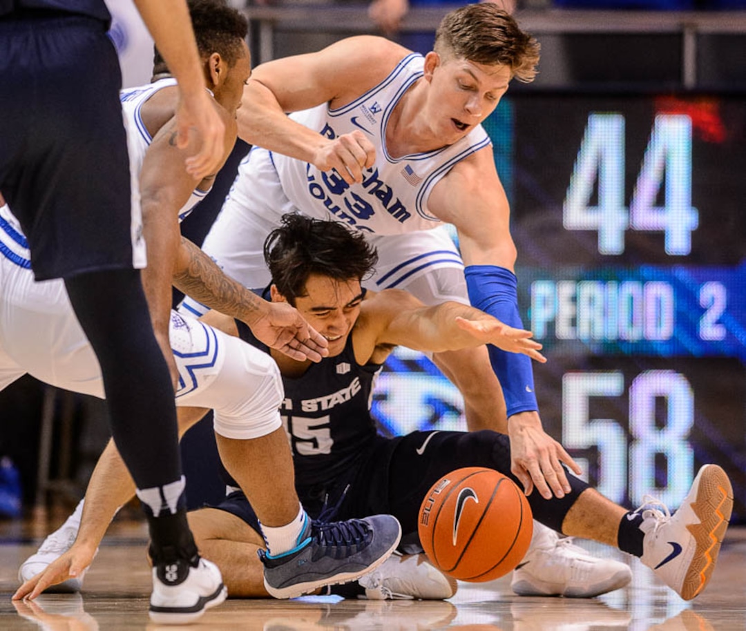 (Trent Nelson | The Salt Lake Tribune)  Brigham Young Cougars forward Dalton Nixon (33) and Utah State Aggies guard Abel Porter (15) scramble for the ball as BYU hosts Utah State, NCAA basketball in Provo on Wednesday Dec. 5, 2018.