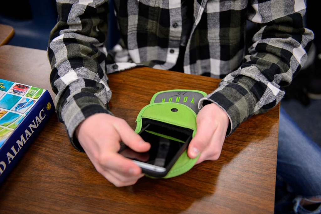 (Trent Nelson | The Salt Lake Tribune) Students secure their phones in locking pouches made by the company Yondr. Friday April 13, 2018.