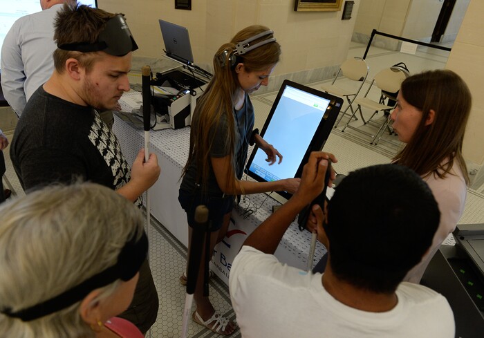 (Francisco Kjolseth  |  The Salt Lake Tribune)  Companies demonstrate new voting machines that can also be navigated by the visually impaired during a hands on presentation at the Capitol on Wednesday, Aug. 2, 2017. The state is considering buying new voting machines. 