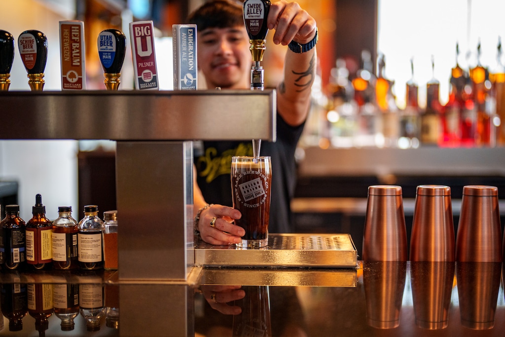 (Trent Nelson  |  The Salt Lake Tribune) Eric Rojas pours a Swede Alley Nitro Stout from Top of Main at Squatters in West Valley City on Monday, Jan. 13, 2025.