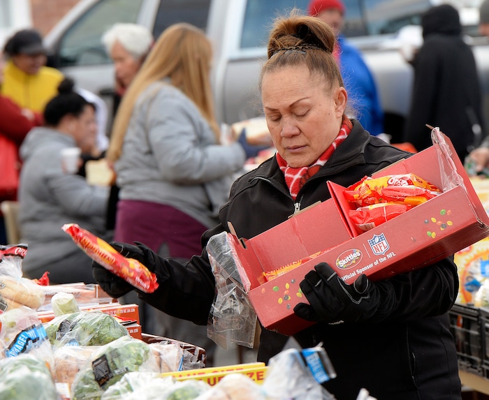 (Al Hartmann | The Salt Lake Tribune)
Volunteer Nola Tuaone of the Utah Food Bank helps pack food boxes in the parking lot of the LDS Church at 1860 S. 300 E. in Salt Lake City Friday April 13. She volunteers every Friday. It's one of 18 locations the bank operates to get food out to the food insecure. An army of volunteers make the distrbution system work. Walmart, Feeding America and Utah Food Bank are teaming up during the month of April to fight hunger through an online and in-store donation campaign.
