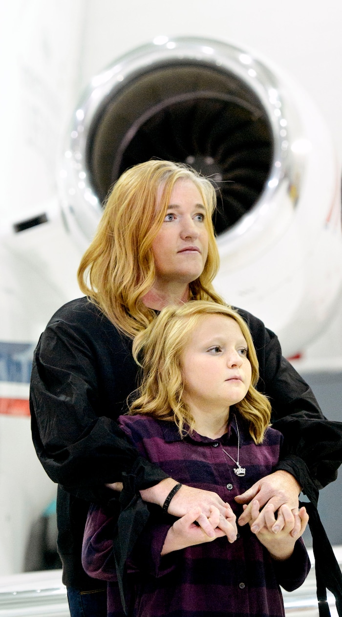 (Steve Griffin  |  The Salt Lake Tribune)  With the new Intermountain Life Flight jet that will be used primarily to retrieve organs for transplantation in the Intermountain West in the background, liver transplant recipient Meinkina Jewkes,12, holds hands with her mother Jennifer during a news conference at the Intermountain Life Flight Hangar at the Salt Lake International Airport in Salt Lake City Monday October 30, 2017. 