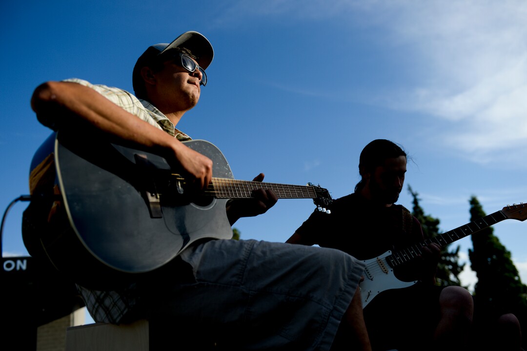 (Leah Hogsten  |  The Salt Lake Tribune) From left, Julian Alvarez plays acoustic guitar to the  accompaniment of bassist John Abegglen. Dozens of yoga enthusiasts filled the Ogden Amphitheater on Thursday, July 25, 2019 during the annual free yoga class sponsored by the Front Yoga Loft and The Front Climbing Club.