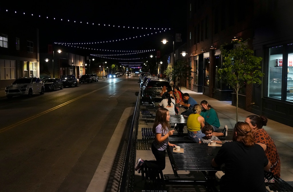 (Bethany Baker | The Salt Lake Tribune) People sit outside Blacksmith Ice Cream Co. along Main Street in Midvale on Friday, Sept. 11, 2026. 