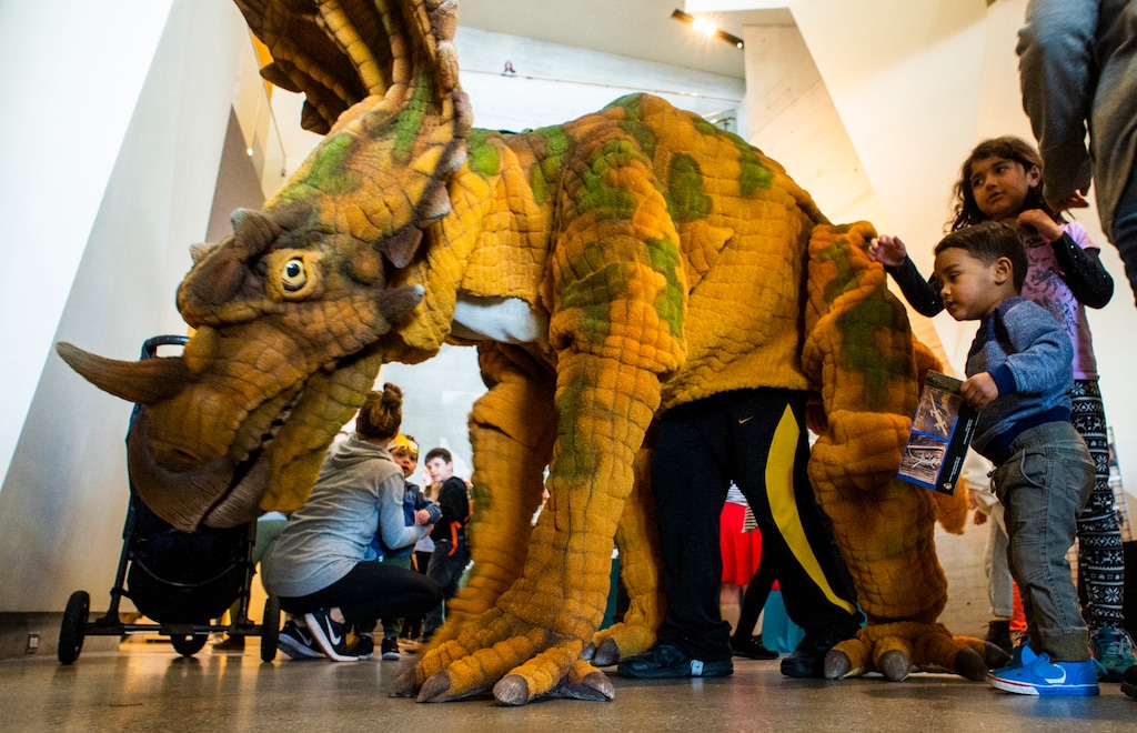 (Rick Egan  |  The Salt Lake Tribune)   The Utahasourus roams around the exhibits, during the Utah Natural History Museum DinoFest.