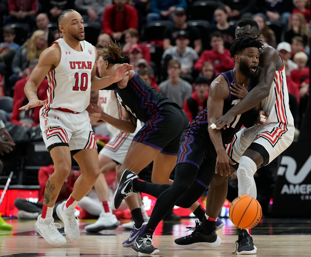 (Leah Hogsten | The Salt Lake Tribune) TCU Horned Frogs guard Mike Miles Jr. (1) collides with Utah Utes center Keba Keita (13) as the University of Utah hosts the TCU Horned Frogs at Vivint Arena, Dec. 21, 2022. 