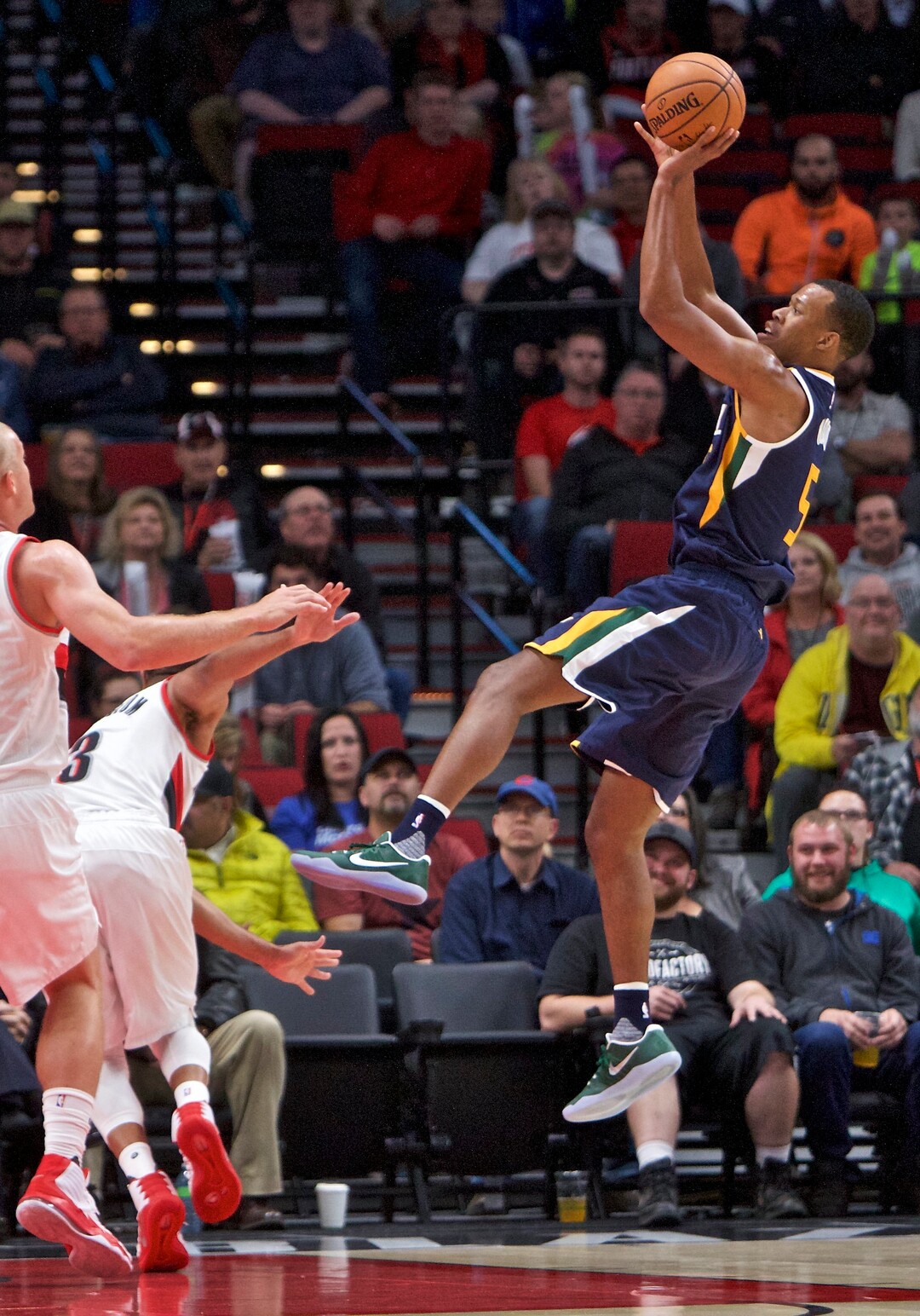 Utah Jazz guard Rodney Hood, right, shoots over Portland Trail Blazers defense during the first half of an NBA preseason basketball game in Portland, Ore., Monday, Oct. 3, 2016. (AP Photo/Craig Mitchelldyer)