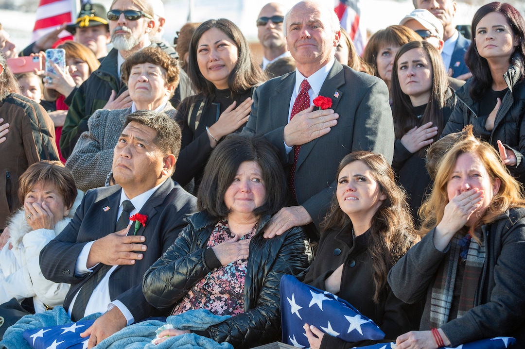 (Rick Egan  |  The Salt Lake Tribune) Family members of Army Chief Warrant Officer 2 Kirk T. Fuchigami Jr. watch as Apache helicopters fly over the Brigham City Cemetery, Monday, Dec. 9, 2019, during the graveside service for Fuchigami, who was killed in Afghanistan last month.