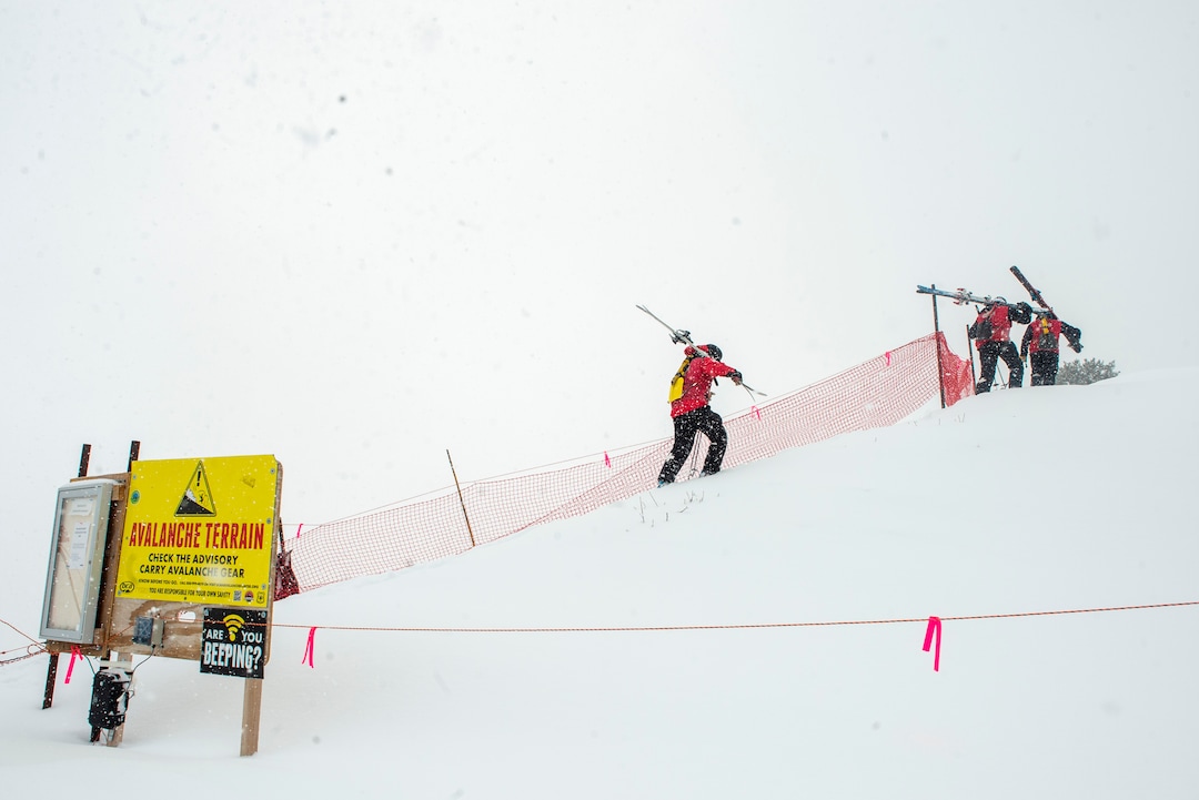 (Rick Egan | The Salt Lake Tribune)  Park City Mountain Resort ski patrollers hike the boot-pack path toward the ski area exit gate on the ridge above the Ninety-Nine 90 lift. Access to the gate has been closed since two men died in January in avalanches in the adjacent unmaintained backcountry areas after leaving the resort through that point.Wednesday, Feb. 24, 2021.