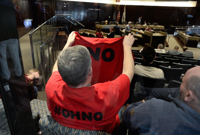 (Francisco Kjolseth | The Salt Lake Tribune) Ron Mortensen of Herriman, overlooks his shirt showing opposition to the proposed Olympia Hills development prior to Salt Lake County Council taking the first of two votes on Tuesday, Feb. 25, 2020, on a set of zoning changes for the controversial new housing and commercial development proposed on unincorporated county land on Herriman's western border. The County Council approved the zoning changes 6-to-3, as residents from Herriman, Bluffdale and Riverton who oppose the project turned out for the hearing to voice their concerns.