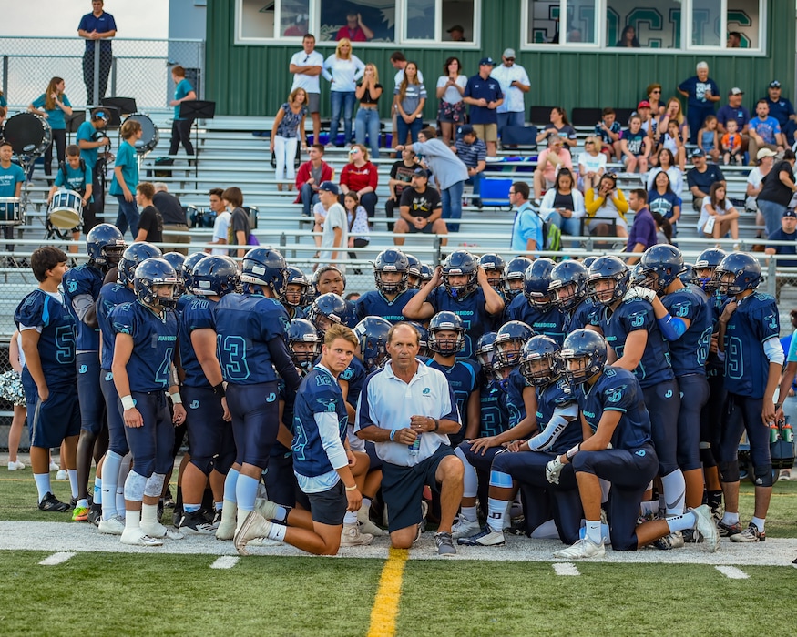 (Juan Diego Catholic High School) John Colosimo with his football team at JDCHS.