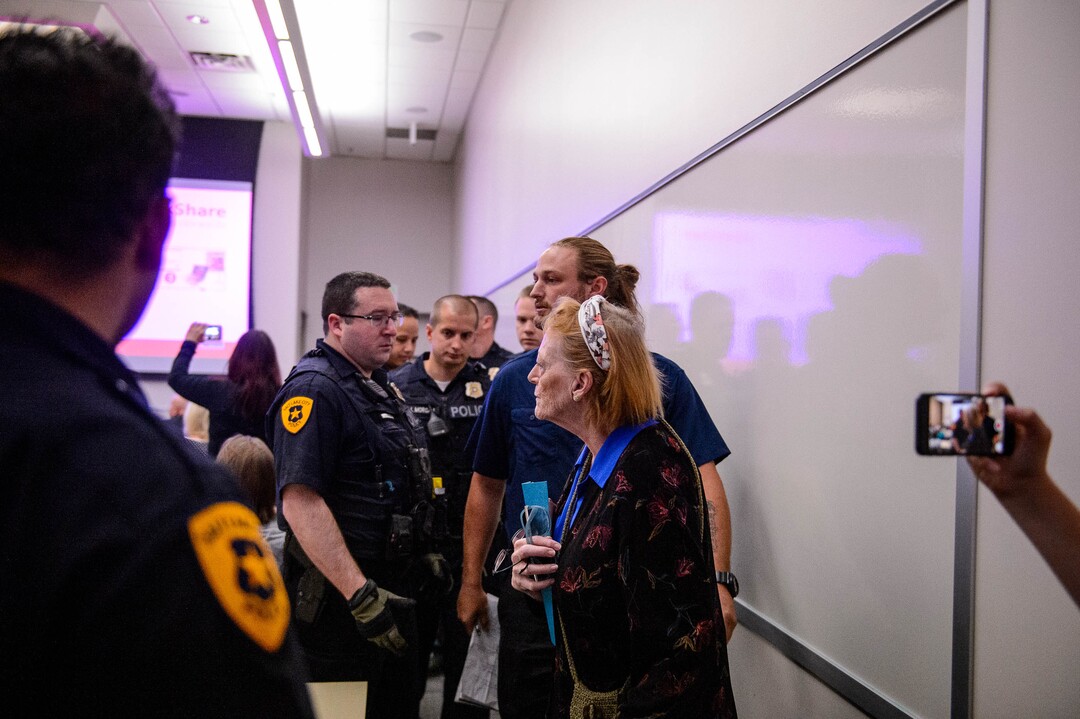(Trent Nelson  |  The Salt Lake Tribune)  
Ethan Peterson argues with police who are removing him from a meeting of an inland port satellite working group (which was quickly canceled), held at a police precinct in Salt Lake City on Wednesday, Aug. 14, 2019. At front is Jill Merritt.