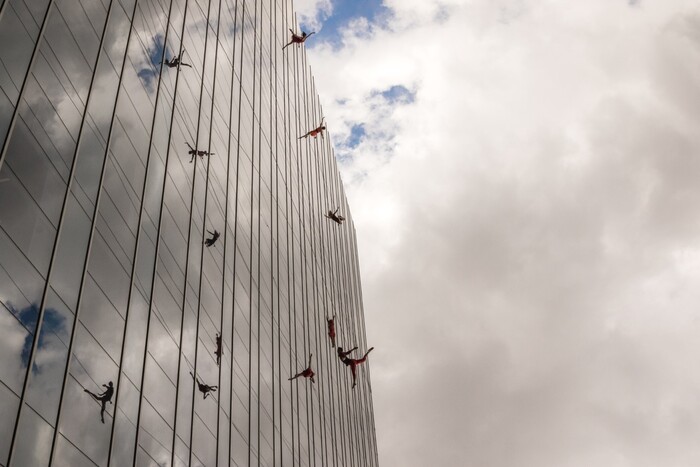 (Photo courtesy of James Adamson) Oakland, Calif.-based “vertical dance” company BANDALOOP performs in Dallas. They will be appearing at the Utah Arts Festival June 21-24, and will perform twice daily (5:30 and 7 p.m.) on the six-story library glass wall above the reflecting pool.