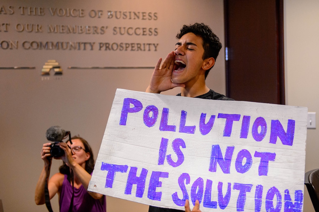 (Trent Nelson  |  The Salt Lake Tribune)  Protesters occupy the Chamber of Commerce office in Salt Lake City on Tuesday, July 9, 2019. Dozens of people showed up to protest the proposed Inland Port and ended up clashing with police, resulting in temporary street closures and arrests.