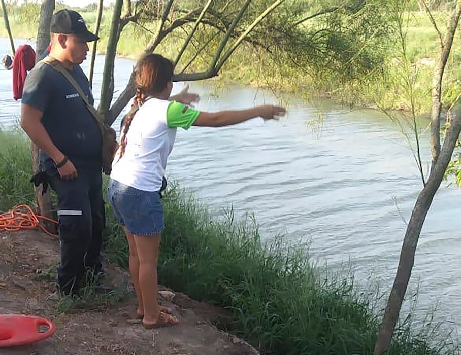 (Julia Le Duc | AP) Tania Vanessa Ávalos of El Salvador speaks with Mexican authorities after her husband and nearly 2-year-old daughter were swept away by the current in Matamoros, Mexico, while trying to cross the Rio Grande to Brownsville, Texas, on June 23, 2019. Their bodies, the toddler still tucked into her father's shirt with her arm loosely draped around him, were discovered Monday morning several hundred yards from where they had tried to cross.
