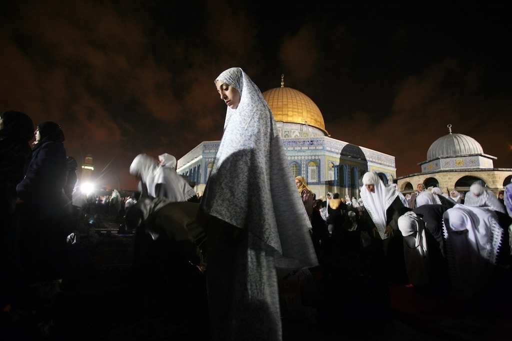 (Rina Castelnuovo | The New York Times)  Muslim women pray outside the Al-Aqsa Mosque in Jerusalem. A commentator is calling for more mosques led by women.