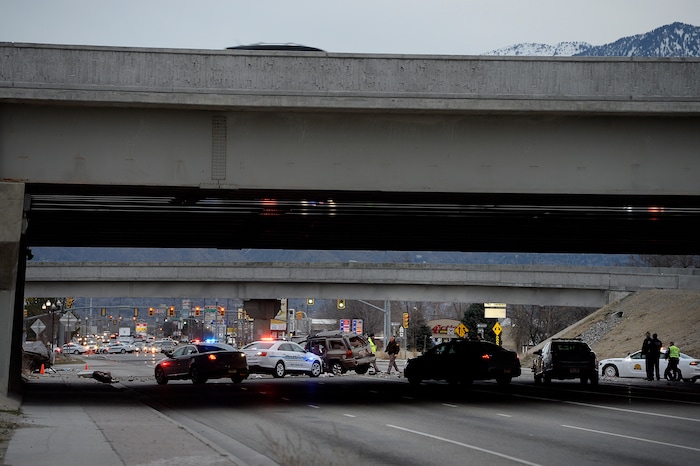 Scott Sommerdorf | The Salt Lake Tribune
The scene of a fatal crash on 3500 South, under the I-215 expressway, Sunday, February, 11, 2018. At the far left is one crashed vehicle, and in the center of the frame, another.