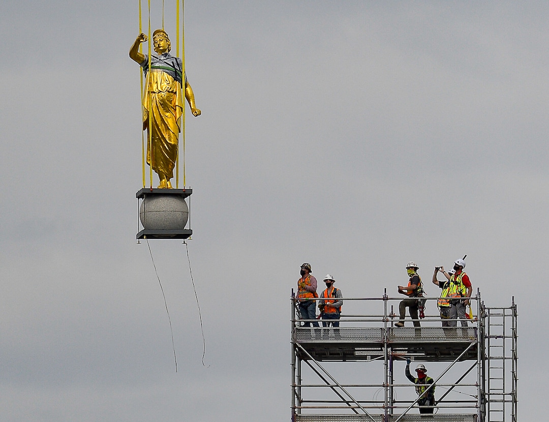 (Francisco Kjolseth  |  The Salt Lake Tribune) Crews work to remove the Angel Moroni statue atop the Salt Lake Temple of The Church of Jesus Christ of Latter-day Saints on Monday, May 18, 2020. The temple closed in December for seismic upgrades and sustained minor damager during the March 18, 2020, magnitude 5.7 earthquake when the trumpet held by the angel fell off and several smaller spire stones were displaced.