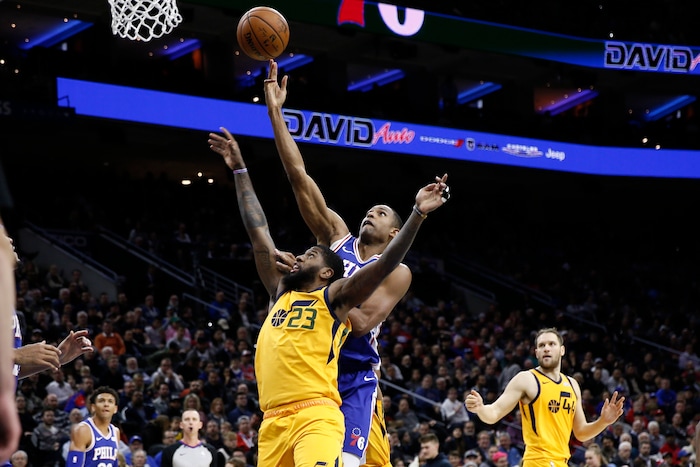 Utah Jazz's Royce O'Neale, center  left, and Philadelphia 76ers' Al Horford leap for a rebound during the first half of an NBA basketball game, Monday, Dec. 2, 2019, in Philadelphia. (AP Photo/Matt Slocum)