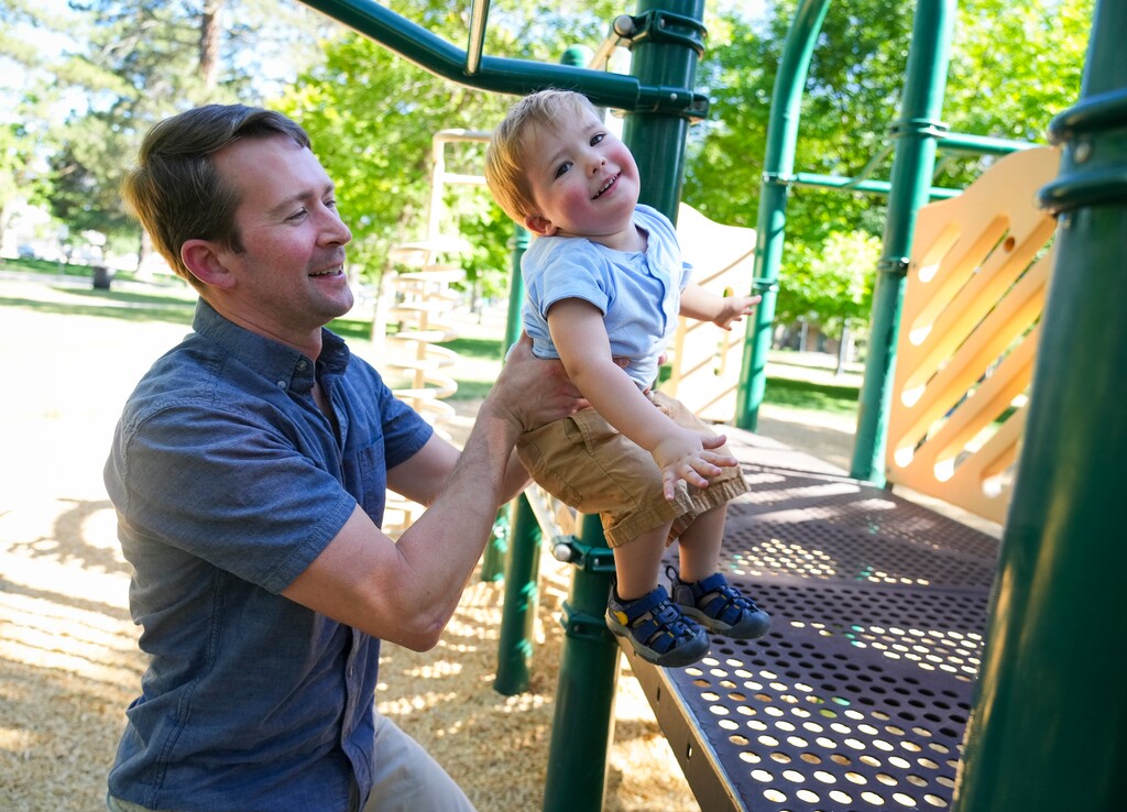 (Bethany Baker | The Salt Lake Tribune) Ethan Comber, 2, plays on the playground with his dad David Comber at Liberty Park in Salt Lake City on Friday, July 11, 2025. Comber's child care costs went from $210 per week to $605 after his son was kicked out of a Department of Defense child care center.