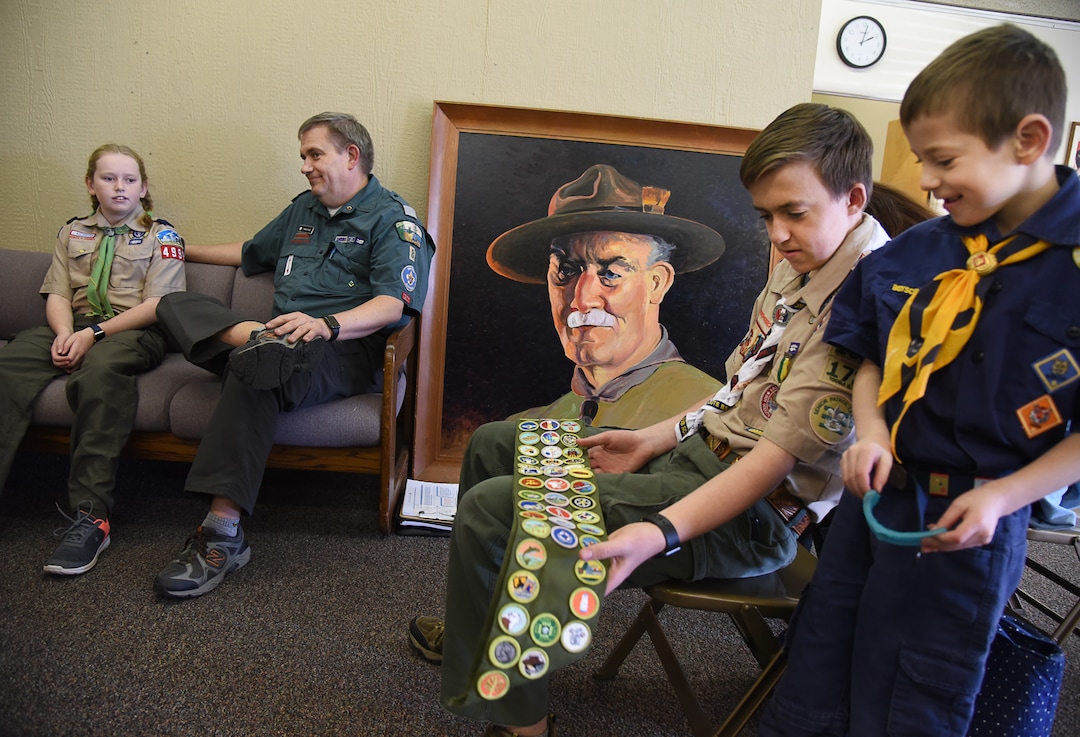 (Francisco Kjolseth  |  The Salt Lake Tribune)  Scouting is a family affair for the Cook family of Tooele as Miriam, left, plans to join the boy scouts on Friday, Feb. 1, when the Boy Scouts of America will begin admitting girls into Scouts BSA. With a portrait of Robert Baden-Powell, founder of the scouts, lying agains the wall nearby, Darwin Cook joins his children Miriam, Kolbie and Sawyer, from left, as they talk about what scouting means to them during a recent visit to the Great Salt Lake Council Boys Scouts of America building in Salt Lake.