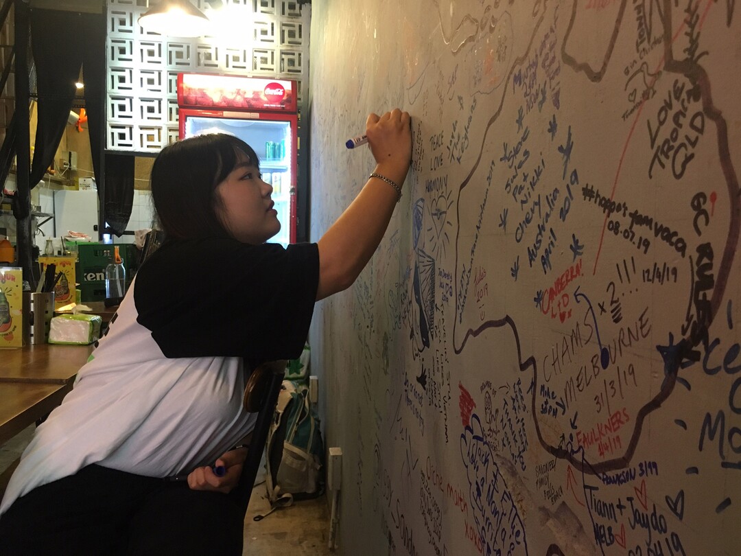 (Matilyn Mortensen | Special to The Tribune) Visitors from around the world have left their mark on the walls of the Nonla Guys restaurant in Ho Chi Mihn City in Vietnam. Some have identified their homes on a large hand-drawn world map, while others have written messages in their native language. There are notes on the wall from residents of each of the six inhabited continents.