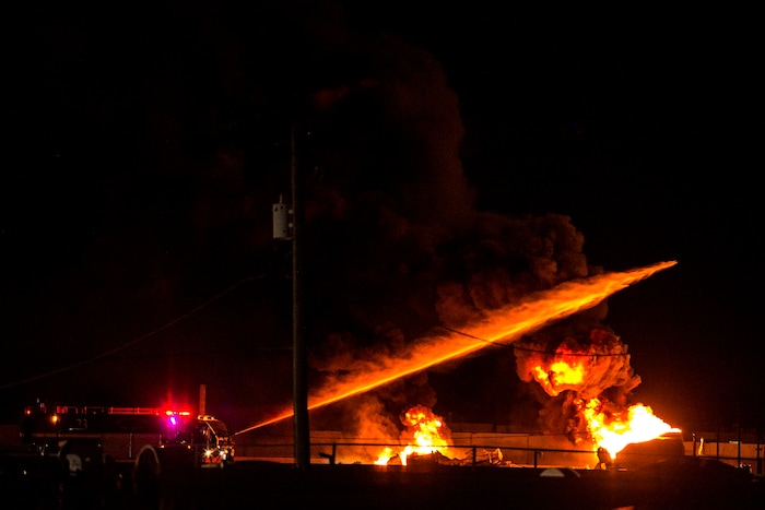 (Chris Detrick  |  The Salt Lake Tribune)  Firefighters attempt to put out a burning semitrailer that was hauling thousands of gallons of fuel on Interstate-15 in Midvale Thursday, January 18, 2018.   Lt. Todd Royce of the Utah Highway Patrol said the truck was southbound on the interstate at 7500 South at 7:20 p.m. when a tire caught fire, sending flames toward the tanks.