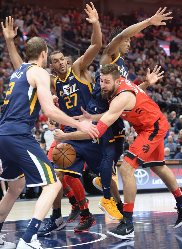 (Leah Hogsten  |  The Salt Lake Tribune) Toronto Raptors center Jonas Valanciunas (17) loses control of the ball under the net trying to break through Utah Jazz center Rudy Gobert (27) and Utah Jazz guard Donovan Mitchell (45).The Utah Jazz were defeated by the Toronto Raptors 100-109 at Vivint Smart Home Arena, Friday, November 3, 2017