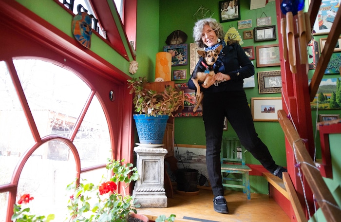 (Francisco Kjolseth  |  The Salt Lake Tribune) Greta deJong, longtime publisher of Catalyst magazine, a Salt Lake City-based magazine for wellness and other New Age topics, talks about the magazine’s HQ, which is also her home on the top floor. Named “Big Pink,” she gives a tour while holding her dog Malia. The magazine is ending its print run after nearly 40 years — shifting to online publication.