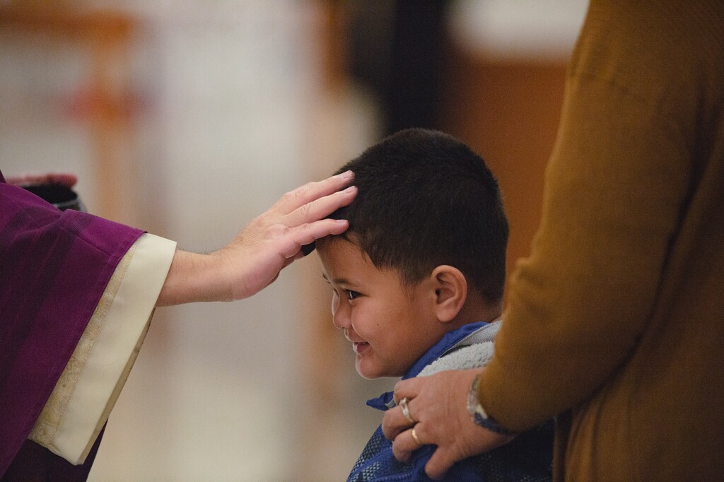 (Rachel Rydalch | The Salt Lake Tribune) Father José A. Barrera places ashes on a young boy's face for Ash Wednesday at St. Joseph the Worker Catholic Church in West Jordan in 2022.