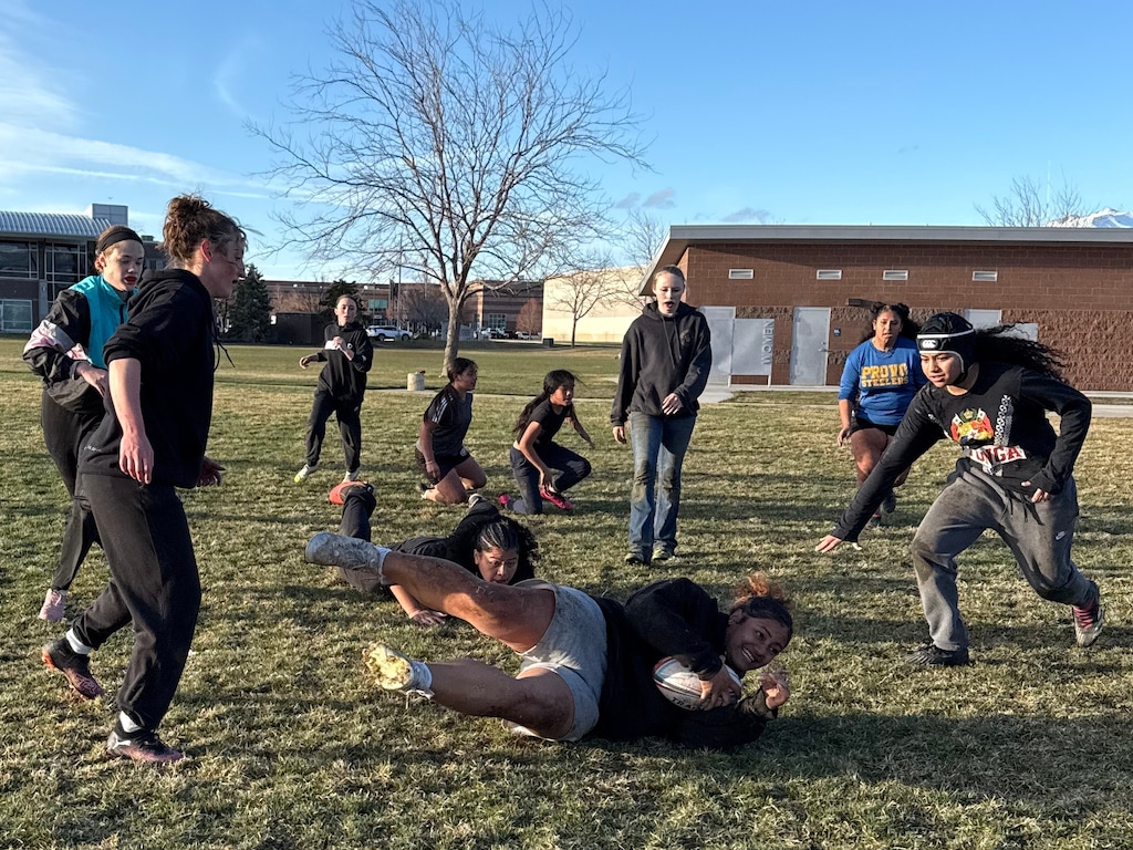 (Elle Crossley | Amplify Utah) The girls on the Layton Christian Academy’s girls club rugby team practice drills at Barnes Park in Kaysville, Utah. Eseta Moala, the first receiver for the team, says tackling is her favorite part of the game.