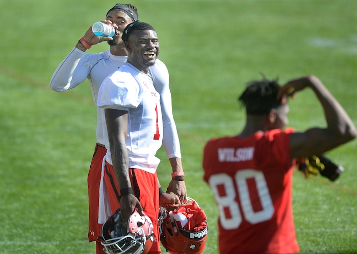 Scott Sommerdorf | The Salt Lake Tribune
Utah QB Tyler Huntley, center, and WR Siaosi Wilson, right, talk with new Utah WR Darren Carrington II, top, after the first day of Utah fall football camp, Friday, July 28, 2017. during the first day of Utah fall football camp, Friday, July 28, 2017.