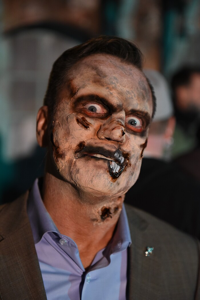 (Francisco Kjolseth  |  The Salt Lake Tribune)  Utah House Speaker Greg Hughes falls prey to the zombie apocalypse with the help of makeup artist Becky Manuel at the Fear Factory on Thursday, Oct. 12, 2017, for a special event to raise awareness of the Utah Food Bank and kick start donations. 