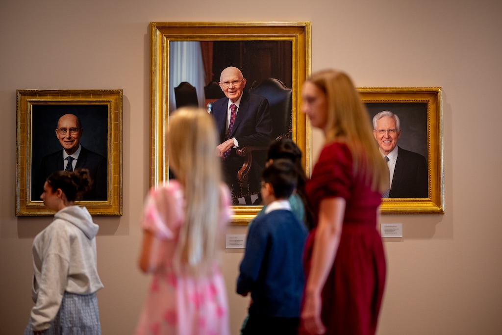 (Trent Nelson  |  The Salt Lake Tribune) People pass portraits of Henry B. Erying, Dallin H. Oaks and D. Todd Christofferson before a session of General Conference of The Church of Jesus Christ of Latter-day Saints at the Conference Center in Salt Lake City on Saturday, Oct. 3, 2026.