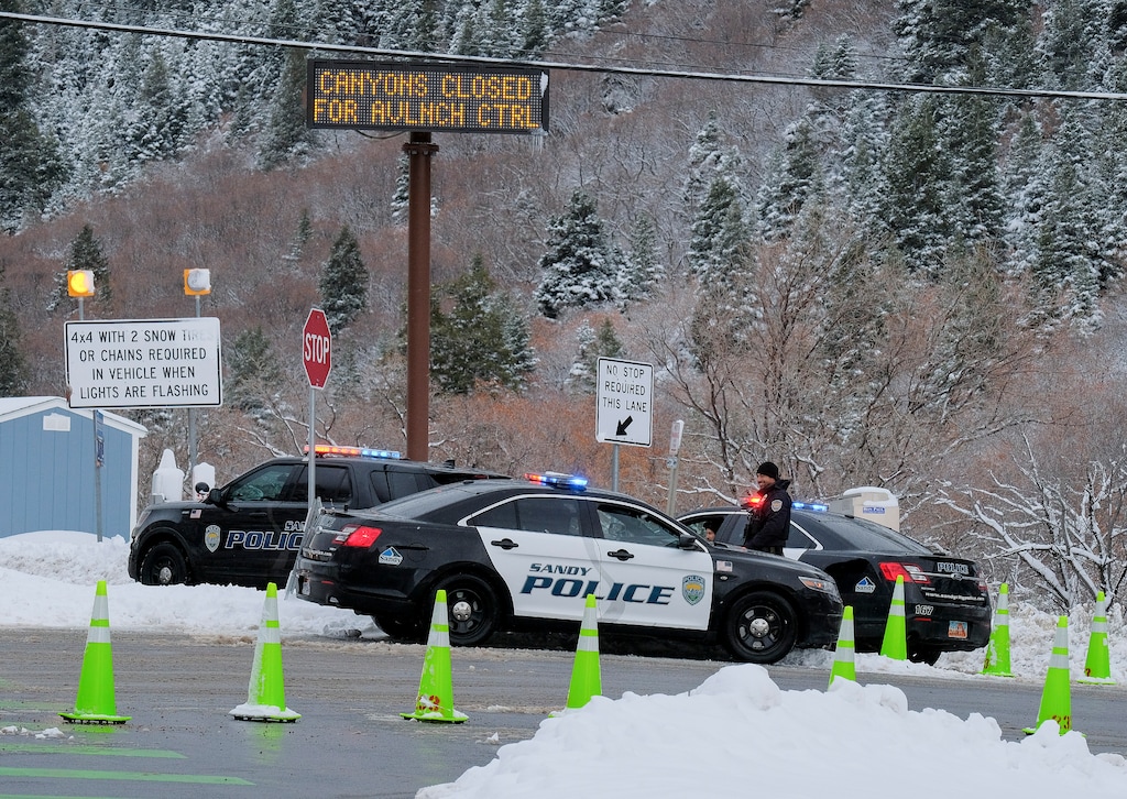 (Leah Hogsten | The Salt Lake Tribune) Sandy Police Department officers stopped traffic in Little Cottonwood Canyon for the day as avalanche mitigation efforts were underway, Feb 16, 2021. A winter weather advisory remained in effect through the following morning along the Wasatch Front and in the Tooele Valley.